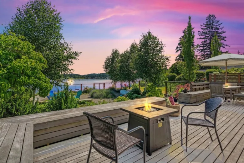 Deck with a fire pit overlooking the beach at sunset