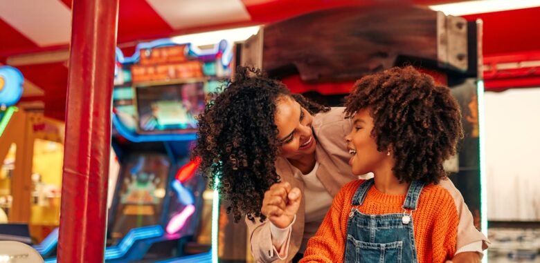 A mom and daughter enjoy an arcade