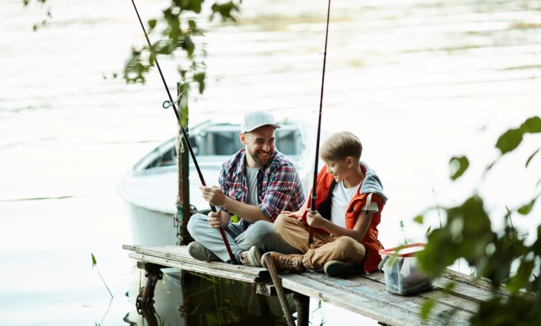 A father and son fish off a dock