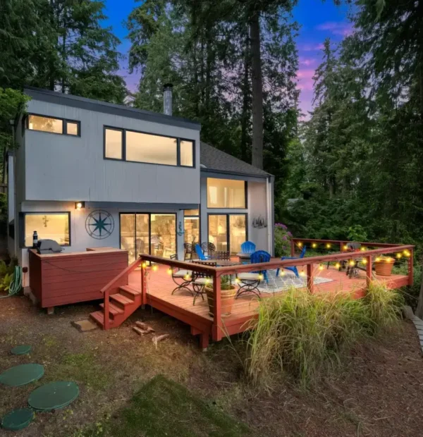 Backyard and deck at sunset surrounded by forest